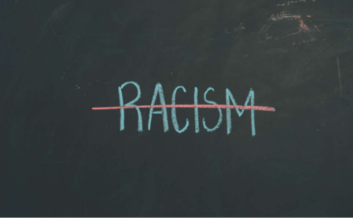 image of the word racism crossed out on blackboard