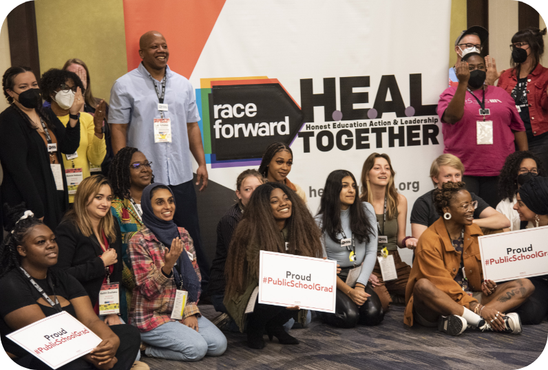 participants of heal together taking a group picture together holding signs